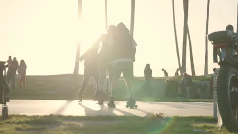 Editorial footage of people roller skating and gathering along a beachfront Stock Footage 329209285