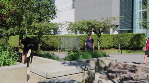 EDITORIAL. Freerunner flips over cement barrier Stock Footage 304777282