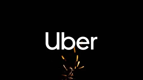 Editorial illustration of tech company Uber on fire sparks. The app Stock Footage 148390016