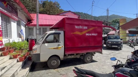 Editorial: Indian postal delivery van standing outside Mallital Post Office in 動画素材 347060697