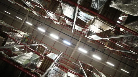 Editorial. large warehouse of consumer goods. a bottom-up look at shelves and sh Stock Footage 220082570