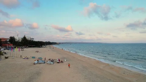Editorial low altitude drone tracking along crowded Mui Ne beach sunset 4K Stock Footage 341092590