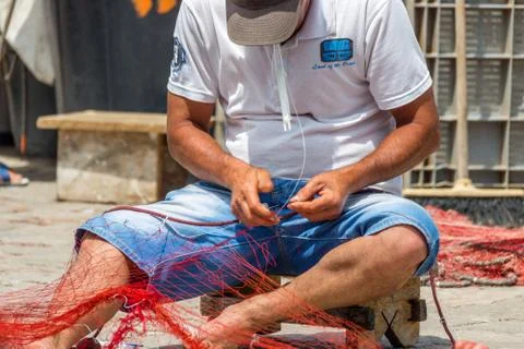 EDITORIAL, Net mending and patching Stockfoto's