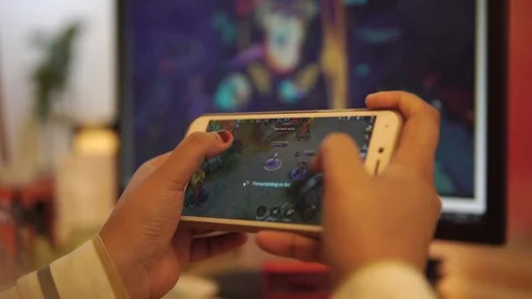 EDITORIAL: A person playing Mobile Legends on phone. Video stock 120030113