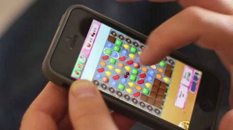 Editorial: Playing the popular app game "Candy Crash" on a smartphone Stock Footage 37075645