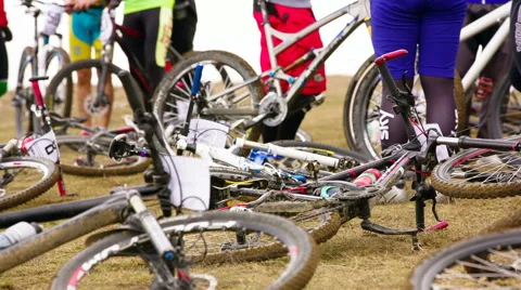 EDITORIAL. Professional Bicycles On The Ground While Sportsmen Preparing For Video stock 50587221