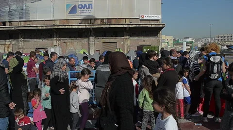 EDITORIAL: Queue for a meal of Syrian refugees in a campground in Greek port Stock Footage 62236024