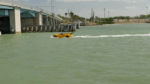Editorial Use Only April 19, 2025. A vibrant yellow car shaped boat cruising at Stock Footage 307253455