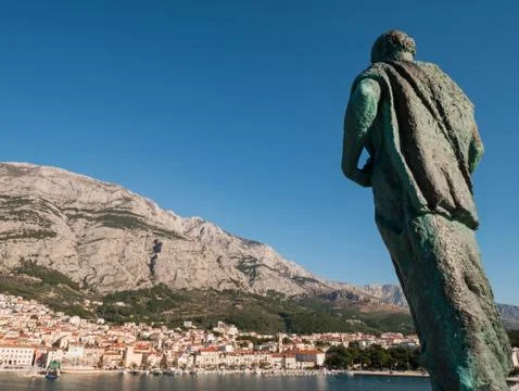 Editoriral - Saint Peter monument in front of city Makarska port Stock Photos