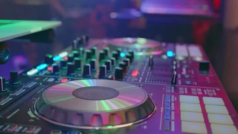 EDM DJ working at underground rave pressing buttons moving sliders. A DJ Stock Footage 303708915