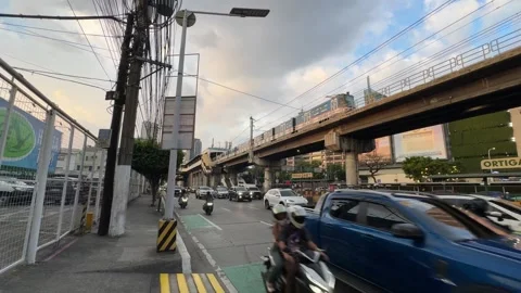 EDSA Ortigas MRT Train Golden Hour Traffic Bike Lane Wide Shot 4K 60fps Stock Footage 338186565