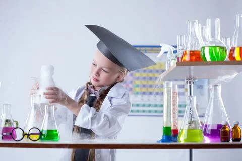 Educated girl following experimental results Stock Photos