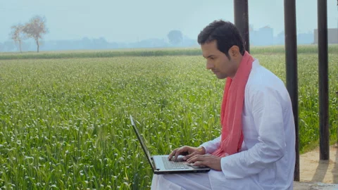Educated Indian farmer learning new things on a laptop - technology concept Video stock 154989644