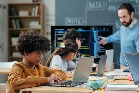 Educating Students in Modern Classroom with Laptops Stockfoto's