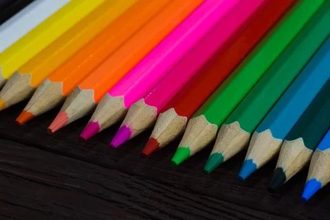Education and creativity concept: colored pencils on wooden background Stock Photos