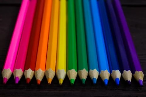 Education and creativity concept: colored pencils on wooden background Stock Photos