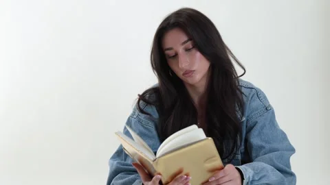 Education and learning concept, young woman reading book in studio, focused Stock Footage 337005814
