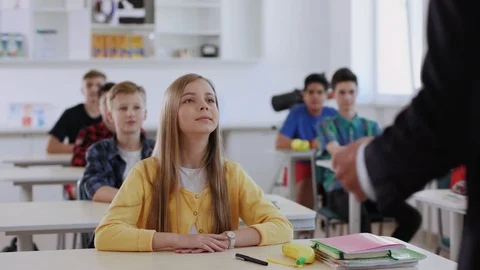 Education and learning process. Students raising their hands while beautiful Stock Footage 111547235