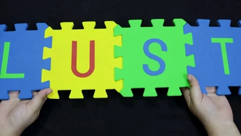Education and spelling concept using interlocking EVA letters word LUST on Stock Footage 319071153