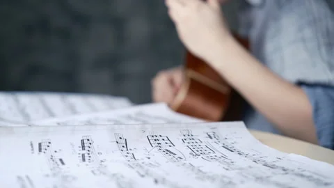 Education classical guitar hands plays classic guitar, music notes Stock Footage 304215903