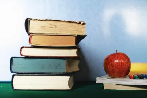 Education concept books stack, apple and pen Stock Photos