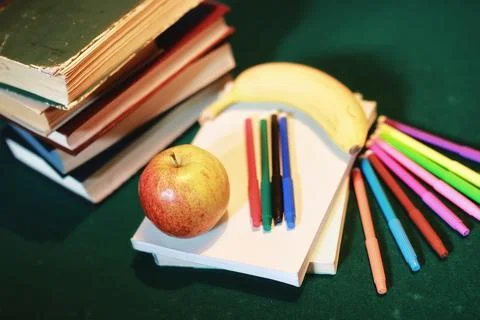 Education concept books stack, apple and pen Stock Photos