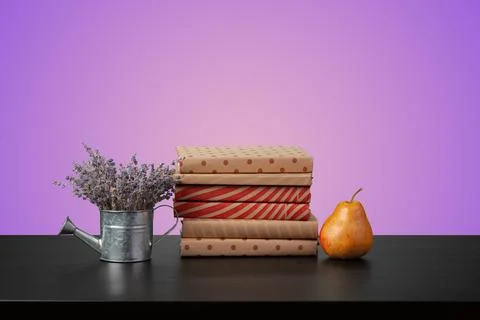 Education concept with stack of books on a table against colored background. 写真素材