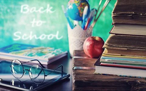 Education concept. A stack of textbooks and a book on the desk with glasses.. 写真素材