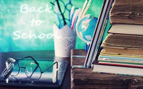 Education concept. A stack of textbooks and a book on the desk with glasses.. Stock Photos