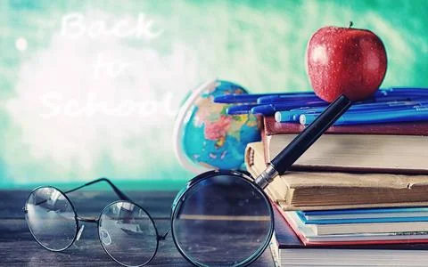 Education concept. A stack of textbooks and a book on the desk with glasses.. 스톡 사진