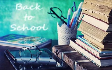 Education concept. A stack of textbooks and a book on the desk with glasses.. 스톡 사진