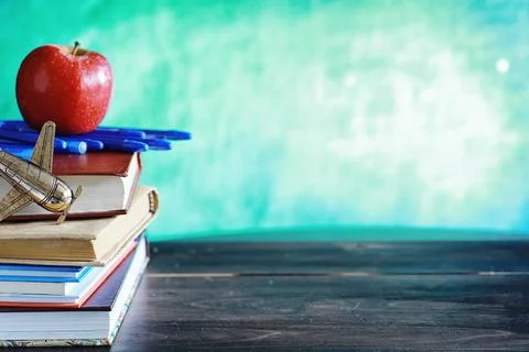 Education concept. A stack of textbooks and a book on the desk with glasses.. Stock Photos