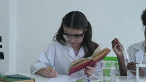 Education concept. Students are experimenting with plants in the laboratory.  Stock Footage 138301413