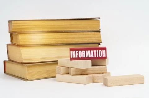 Education concept. On a white surface, a stack of books and wooden blocks, on Stock Photos