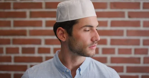 Education, face and thinking with Muslim man on brick wall background at college Stock Footage 336644413
