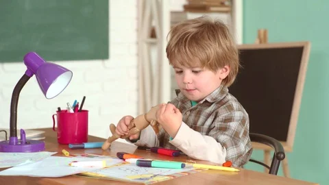 Education first. Pupil in Classroom. Elementary school kids in classroom at Stock Footage 128297022