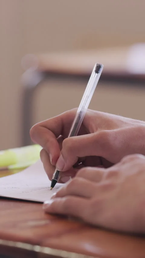 Education, hands of student and writing in classroom for math exam, quiz answer Stock Footage 327194622
