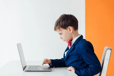 Education IT knowledge child sitting at a laptop at school 写真素材