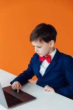 Education IT knowledge child sitting at a laptop at school Stockfoto's