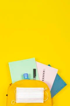 Education, learning, back to school during pandemic. Top view to open backpack Stock Photos
