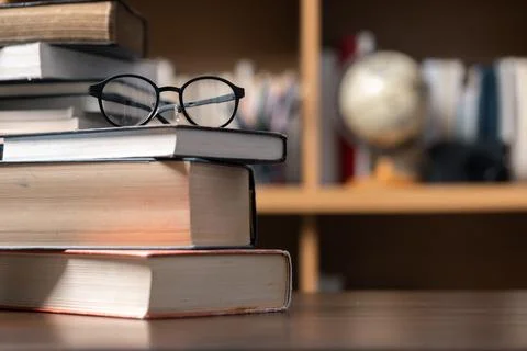 Education learning concept. Book in library with old open textbook, stack p.. Stock Photos