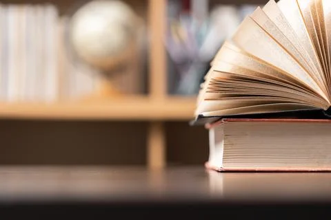 Education learning concept. Book in library with old open textbook, stack p.. Stock Photos