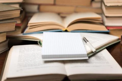 Education learning concept with open book and notebook on the table. Stack pi Stock Photos