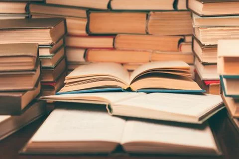 Education learning concept with open book and notebook on the table. Stack pi Stock Photos