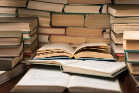 Education learning concept with open book and notebook on the table. Stack pi Stock Photos
