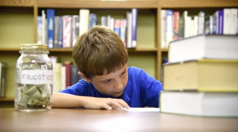 Education Library Boy Saving for College Video stock 52930049
