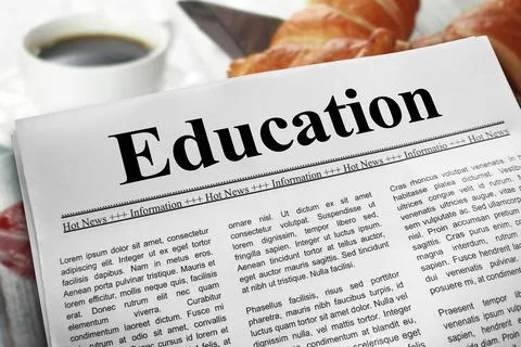 Education in newspaper layout on a breakfast table with a blurry cup of cof.. Stock Photos