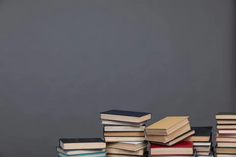 Education science stack of books in the library on a gray background Фото