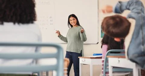 Education, teacher and math answer in classroom for multiplication solution Stock Photos