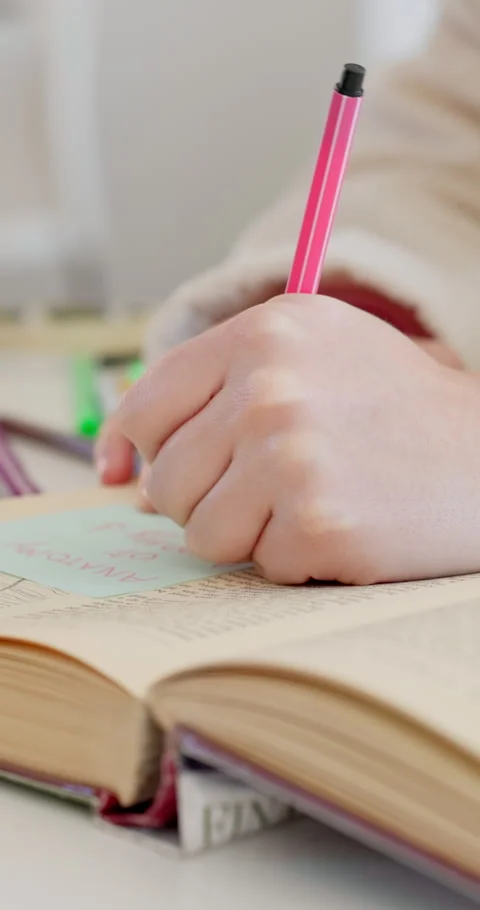 Education, writing and hands of student with sticky note for book annotation Stock Footage 334041869